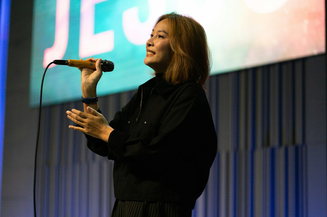 woman speaking confidently on stage