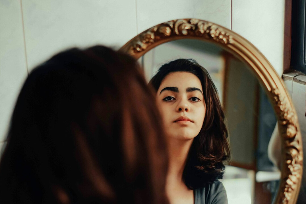person looking at mirror thoughtfully