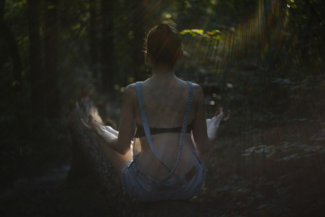person meditating outdoors